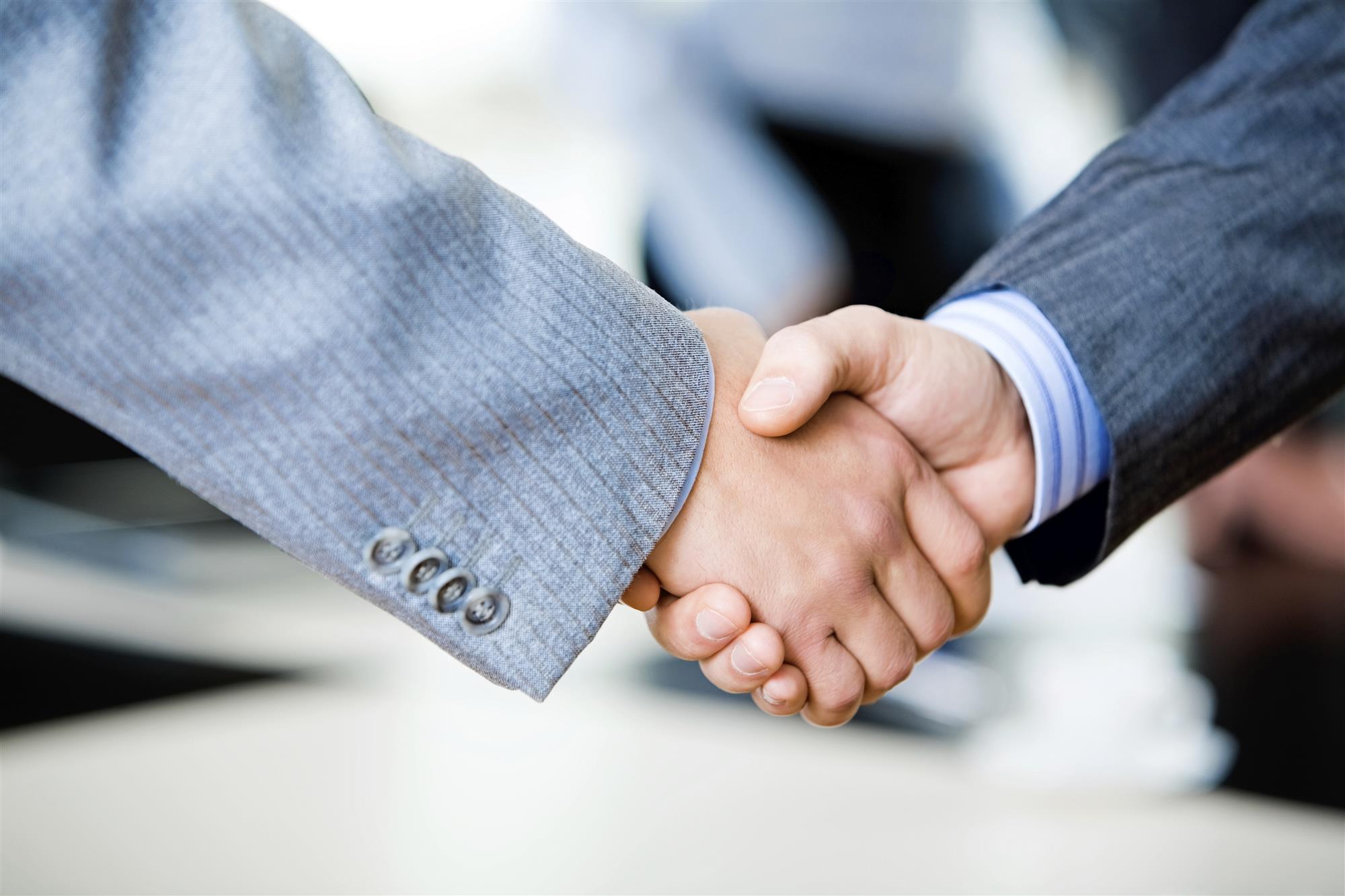 Two professionals completing a business agreement